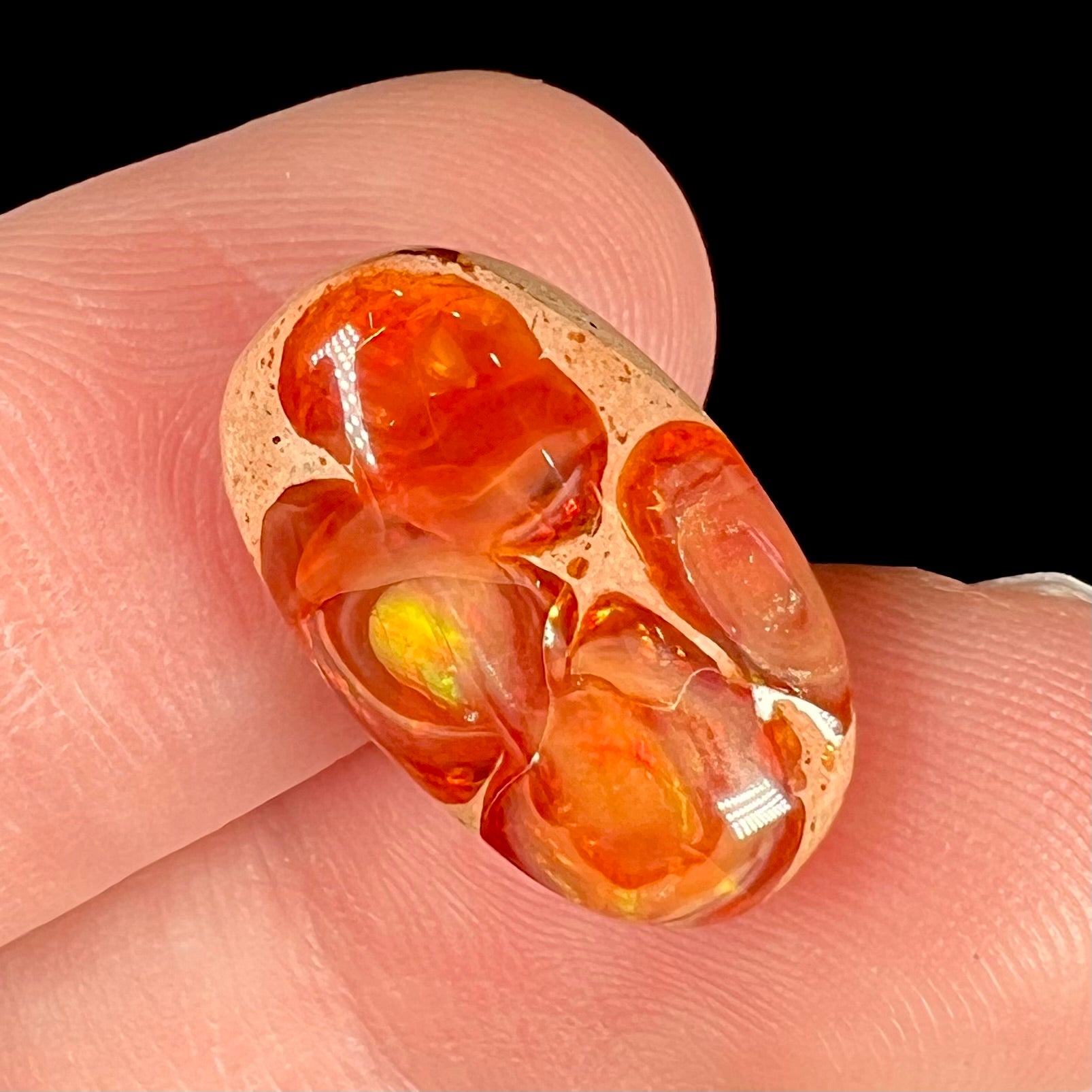 A loose Mexican matrix fire opal stone.  The opal is orange with green flashes.