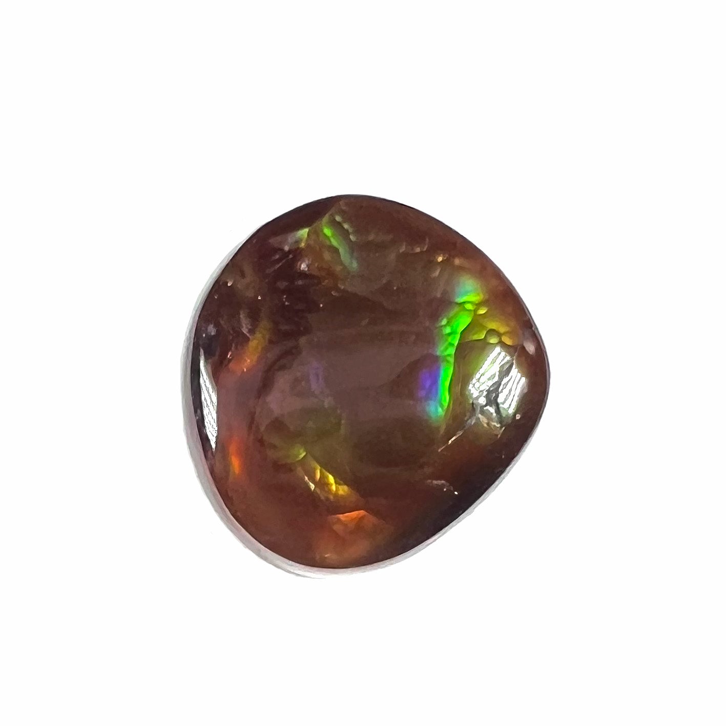 A loose, round cabochon cut Mexican fire agate gemstone.  The stone has a sagenite inclusion.