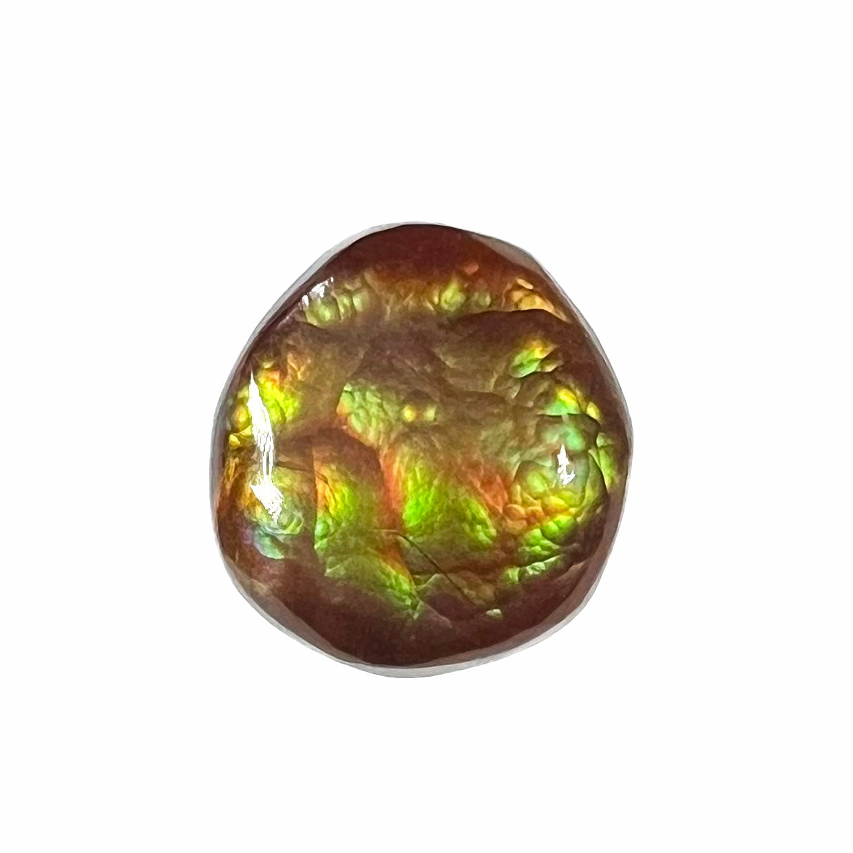 An iridescent green, yellow, and red Mexican fire agate stone.  The stone is an off-round cabochon.