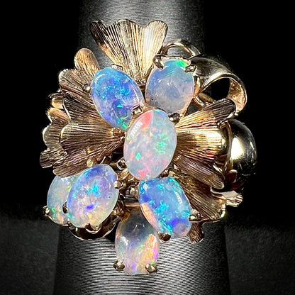 A ladies' vintage, modernist style opal cluster ring in yellow gold.  The ring is tall with a high profile.