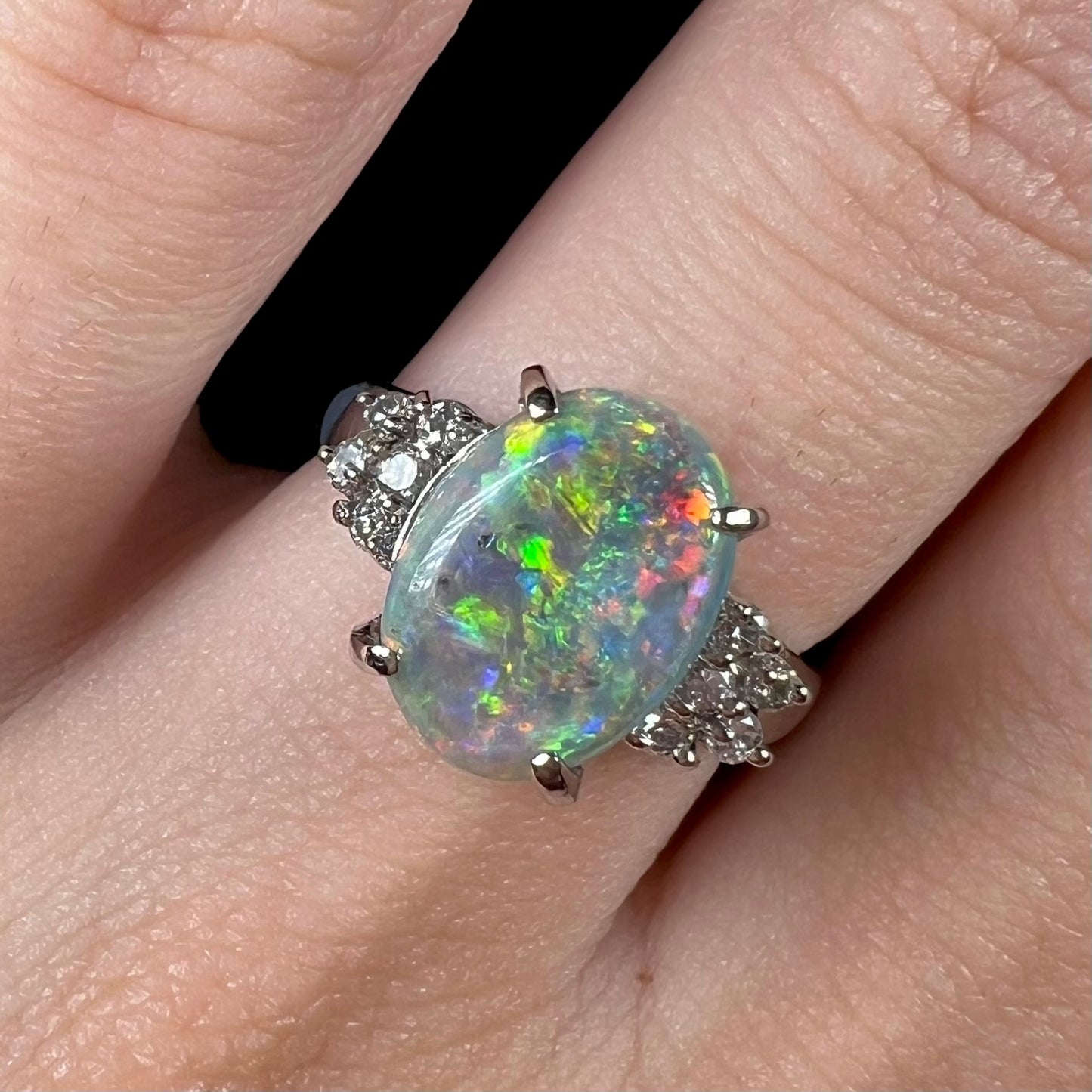 A multicolor Lightning Ridge opal and diamond-accented ring in platinum.