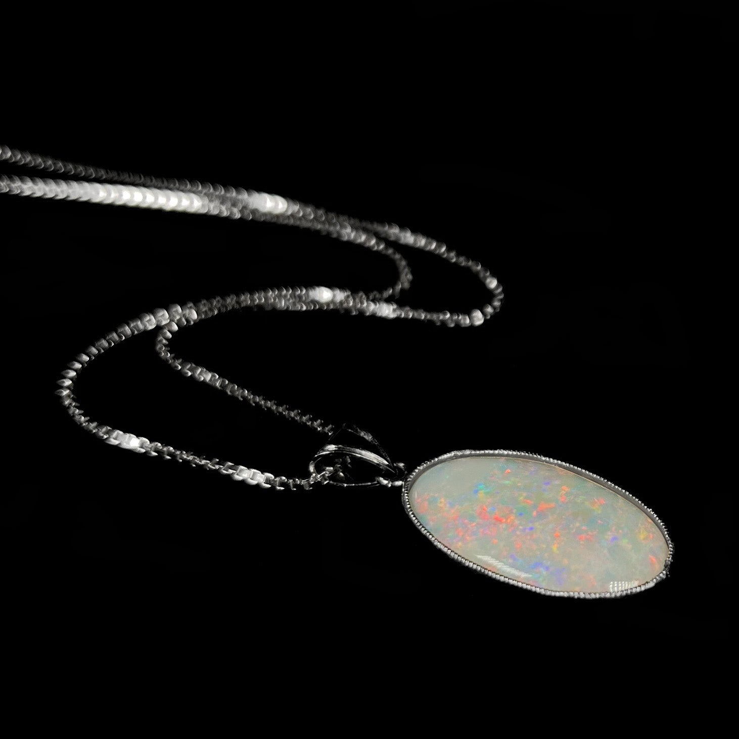 A platinum pendant mounted with an oval cut Australian white opal.