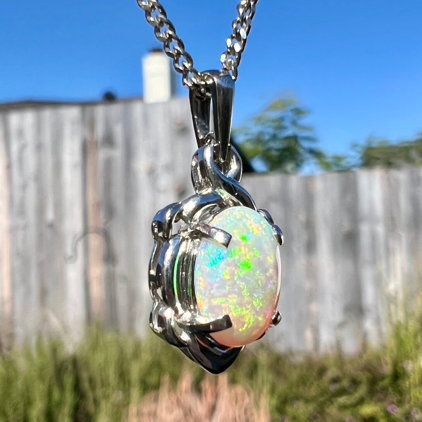 A platinum opal necklace on a platinum chain.  The opal weighs 1.49ct and has predominantly green color play.