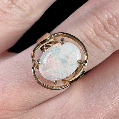 A yellow gold solitaire ring mounted with an oval cut Australian white opal.