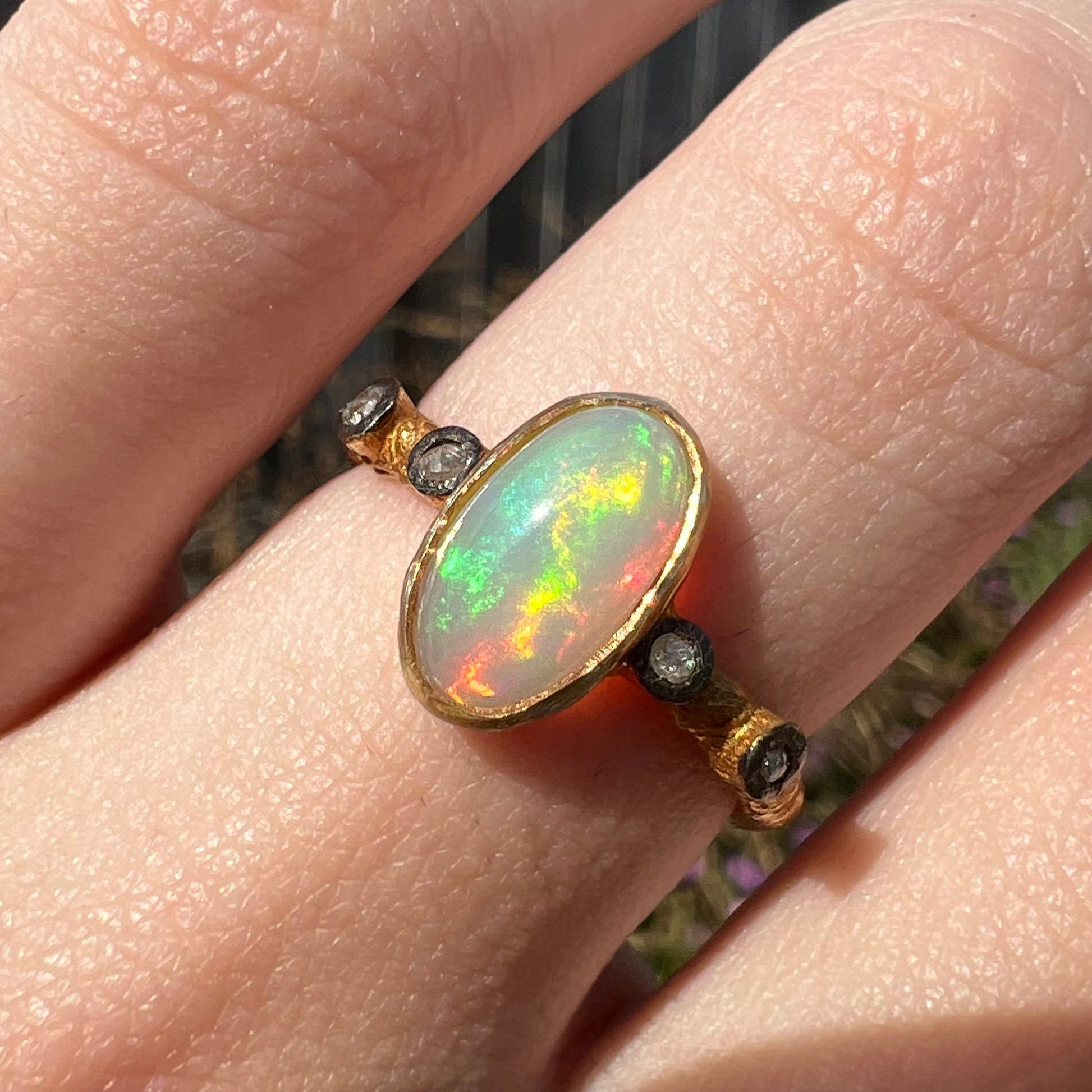 A yellow gold plated sterling silver ring mounted with an Ethiopian fire opal and rose cut diamond accents.