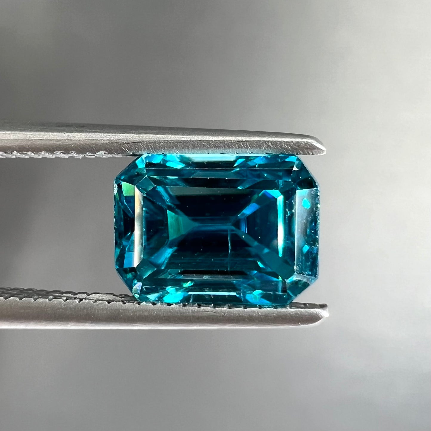 A natural blue zircon gemstone.  The stone is emerald cut.