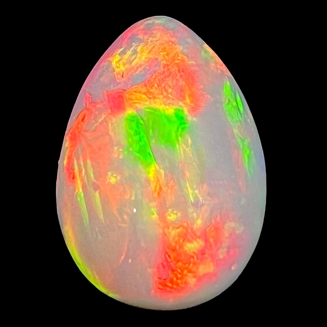 A pear shaped Ethiopian fire opal with vivid red and green play of color.