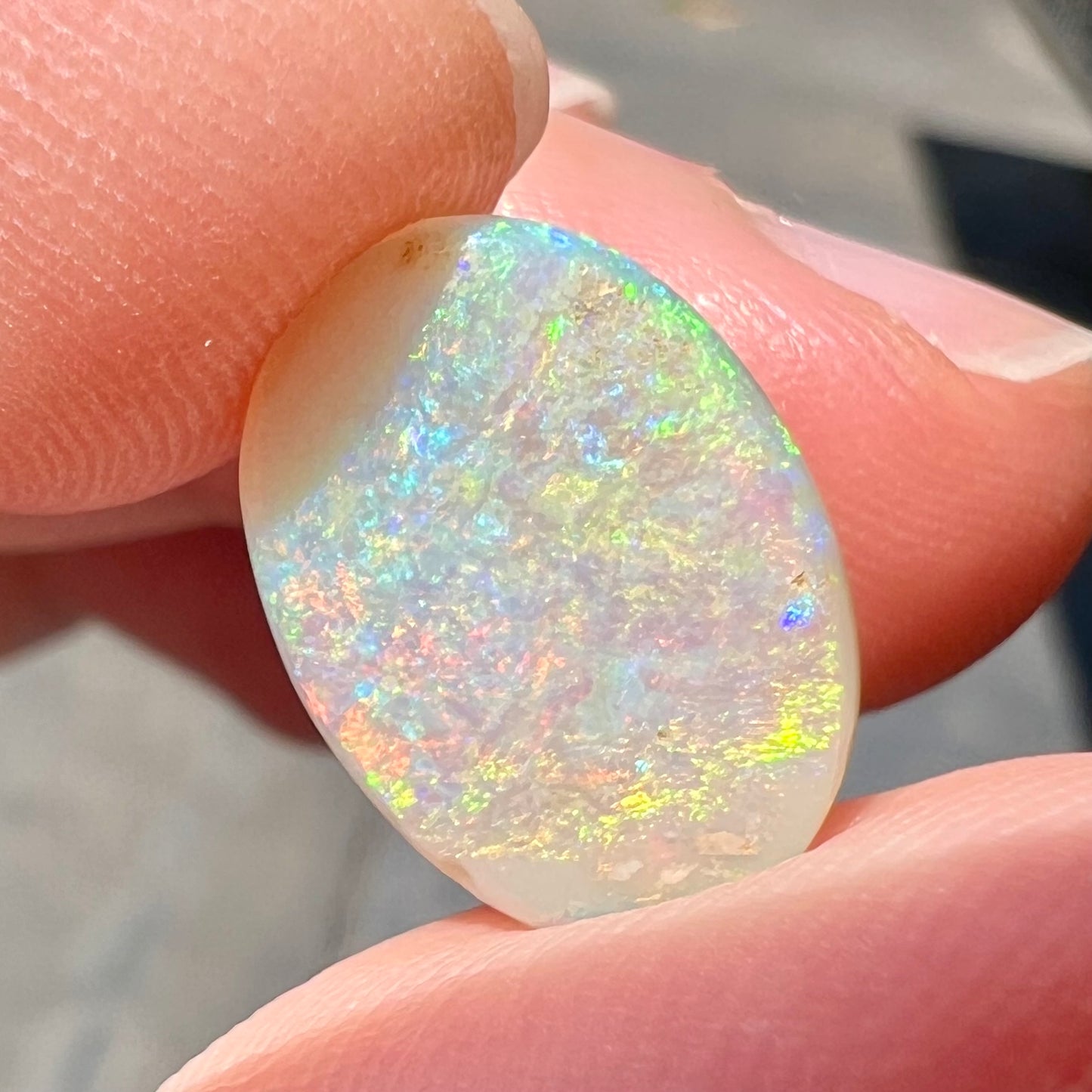 A double-sided opal stone from Coober Pedy, Australia.  The opal plays green, blue, and orange colors from the front and the back.