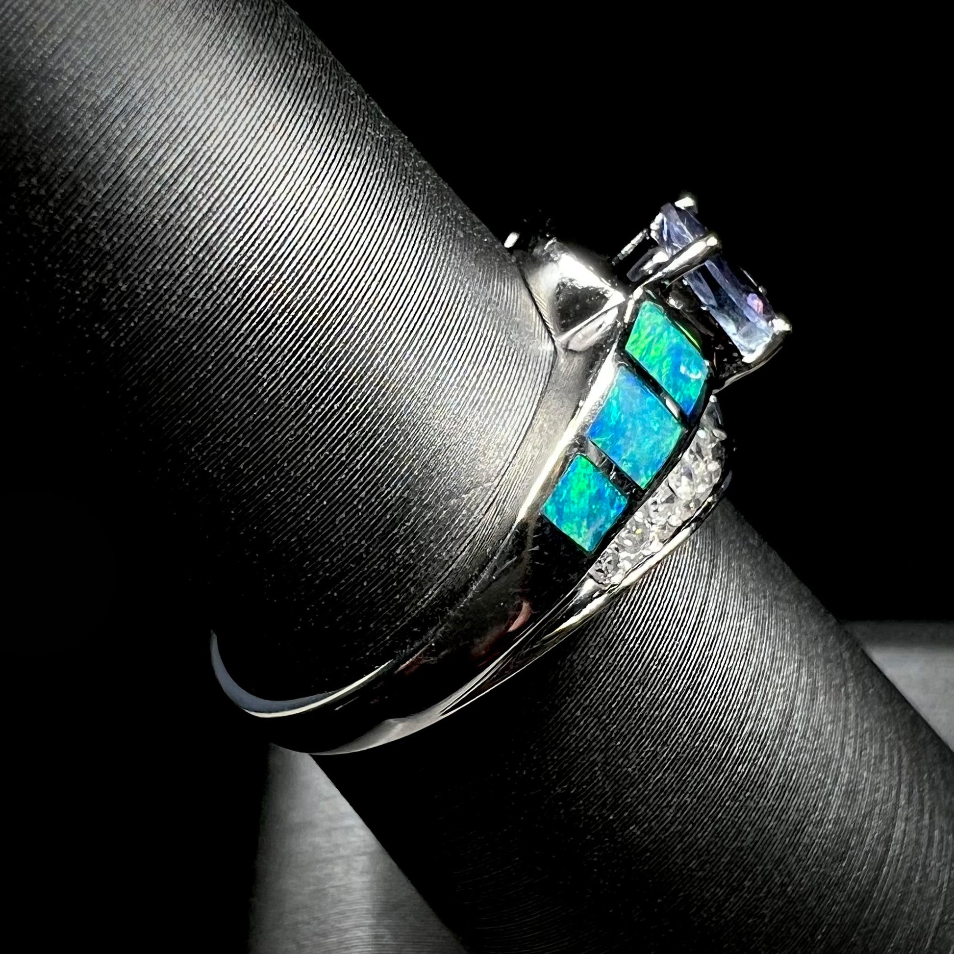 A ladies' white gold tanzanite ring with black opal doublet and diamond accents.