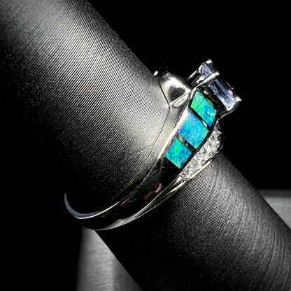 A ladies' white gold tanzanite ring with black opal doublet and diamond accents.