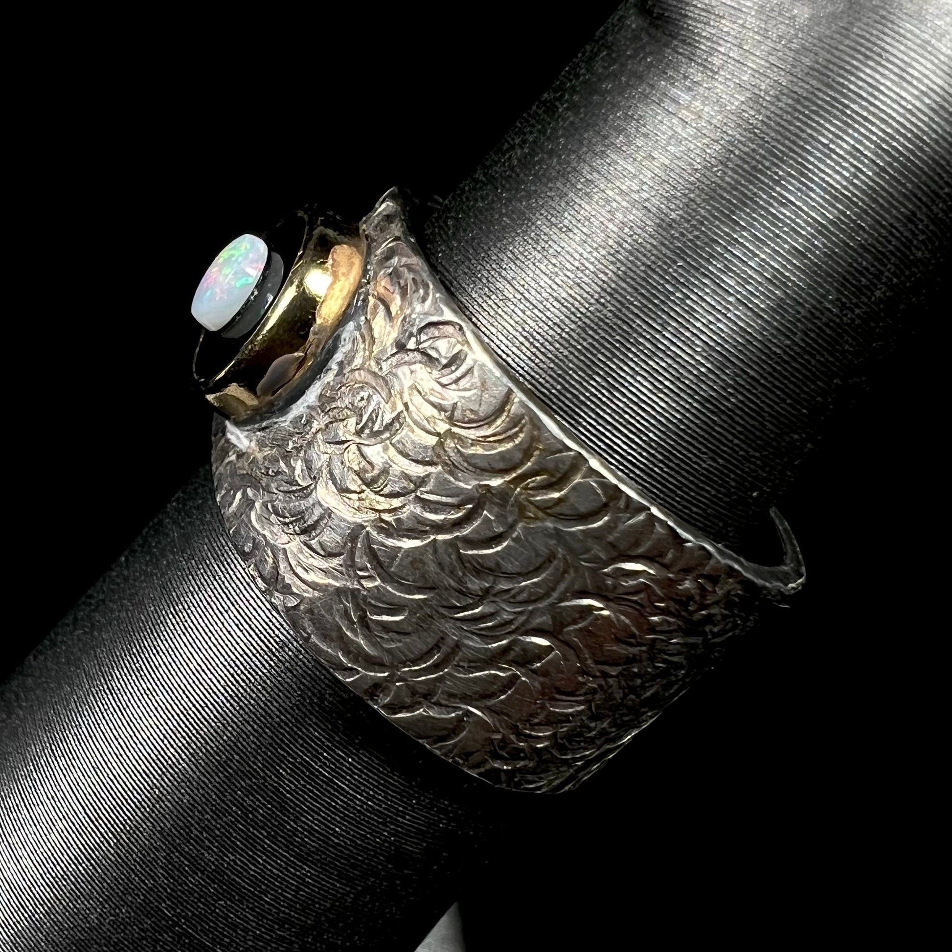 An opal and black onyx inlay ring in a sterling silver cigar-style pinkie ring.