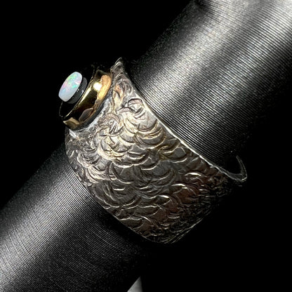 An opal and black onyx inlay ring in a sterling silver cigar-style pinkie ring.