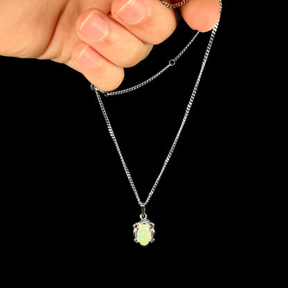 A platinum opal necklace on a platinum chain.  The opal weighs 1.49ct and has predominantly green color play.