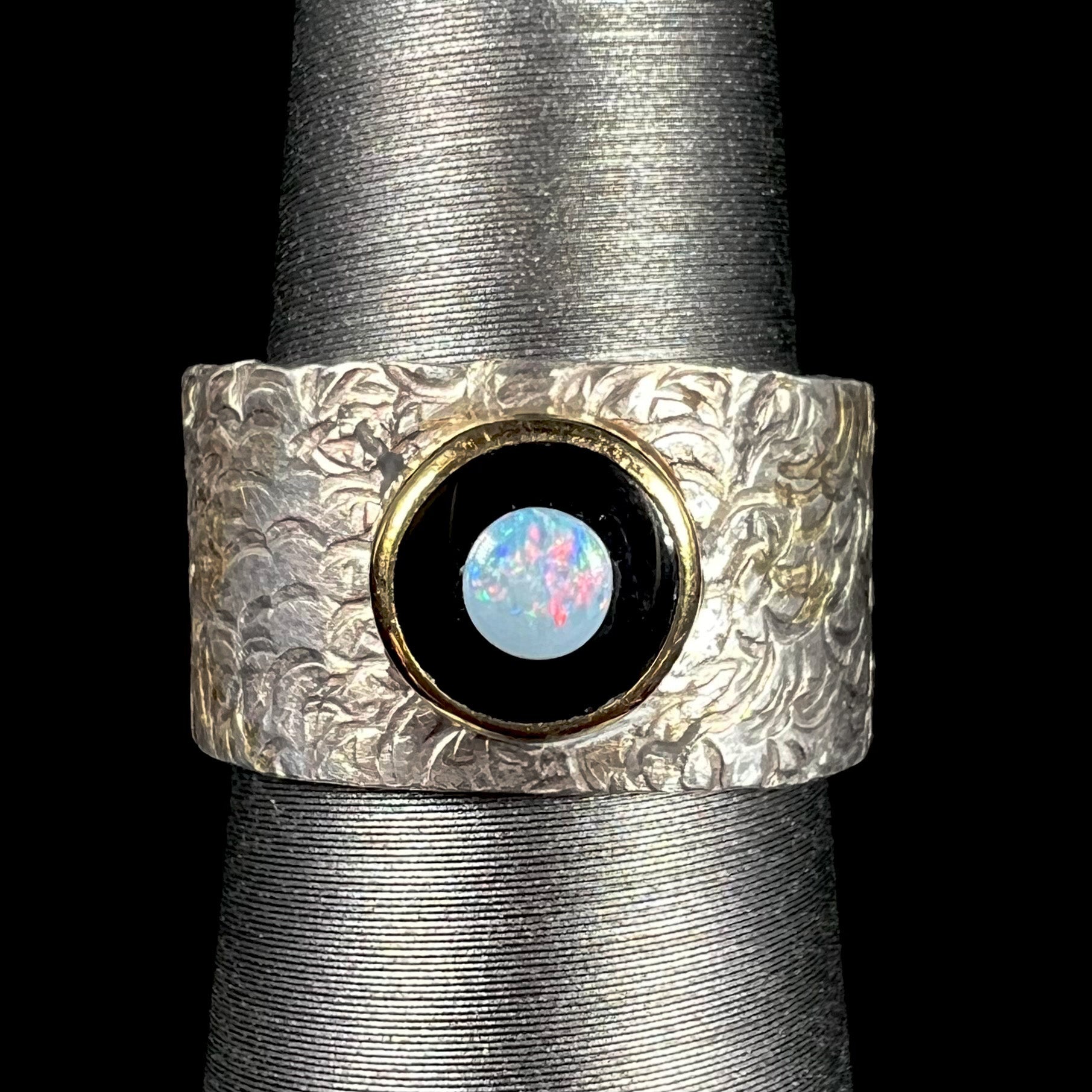 An opal and black onyx inlay ring in a sterling silver cigar-style pinkie ring.