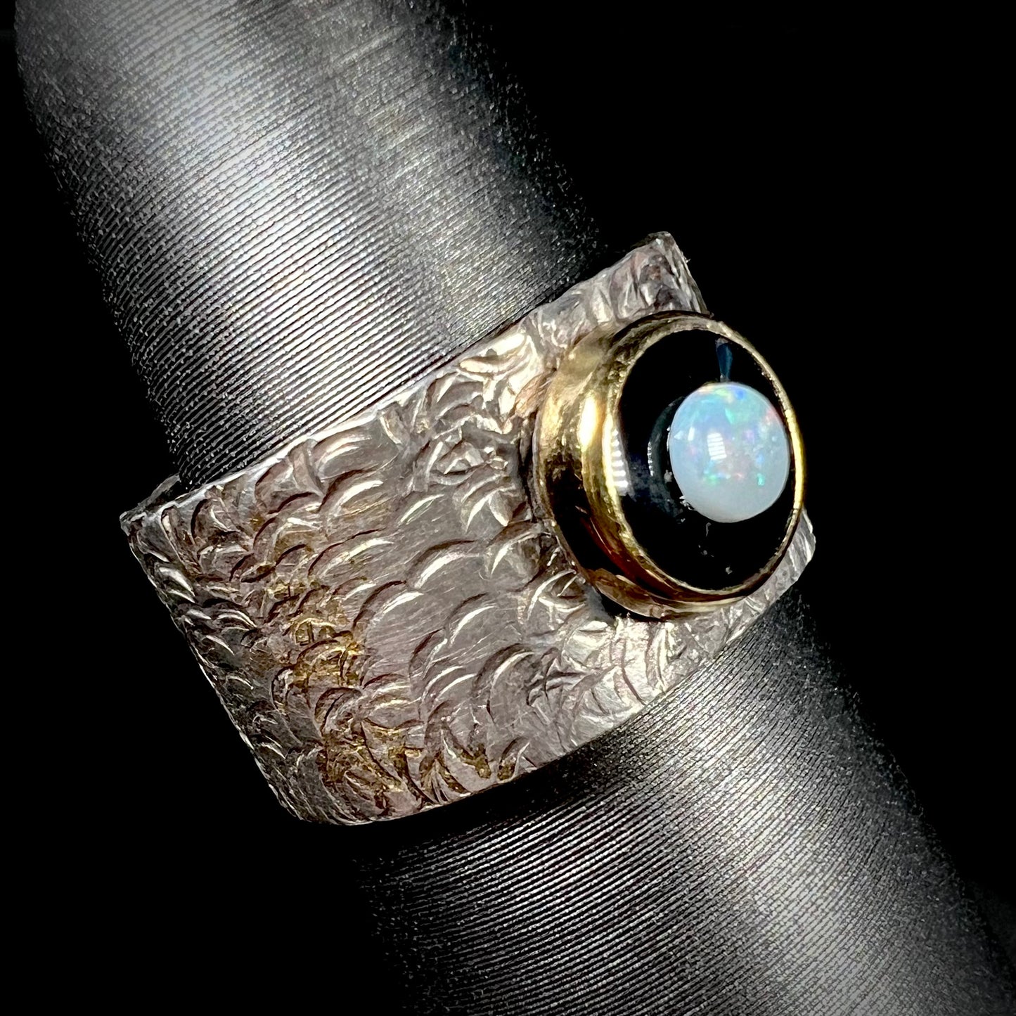 An opal and black onyx inlay ring in a sterling silver cigar-style pinkie ring.