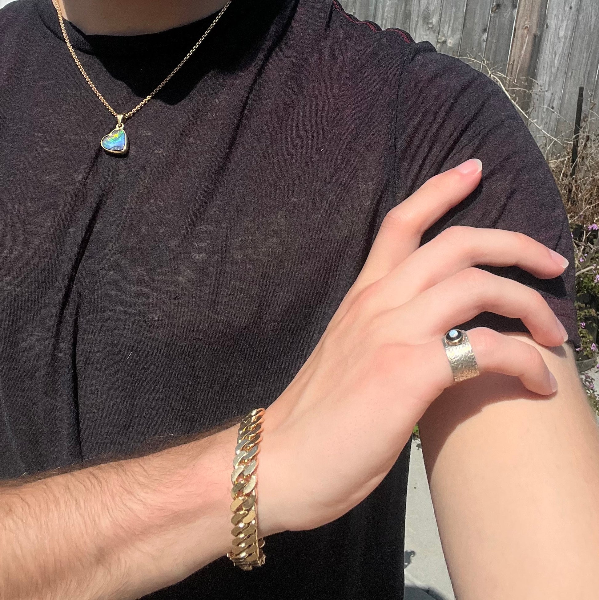 An opal and black onyx inlay ring in a sterling silver cigar-style pinkie ring.