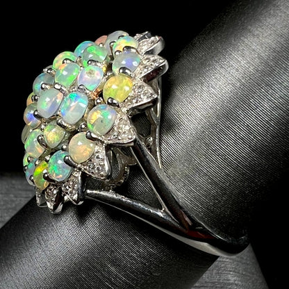 A sterling silver cluster flower ring mounted with 33 round Ethiopian fire opals.