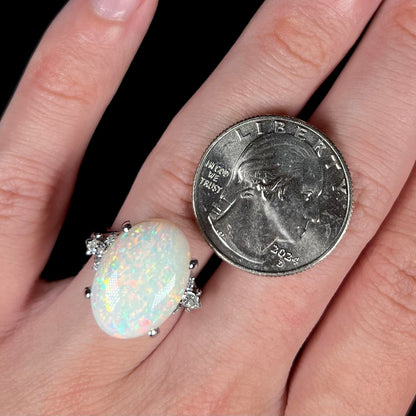 A platinum statement ring mounted with a 7.97ct Coober Pedy opal and marquise cut diamond accents.