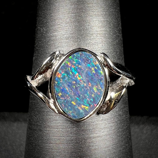 A silver leaf-style ring mounted with a multicolor black opal doublet.