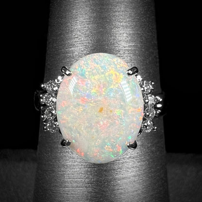 An Australian opal and diamond engagement ring in platinum.  The ring has filigree scrolling.