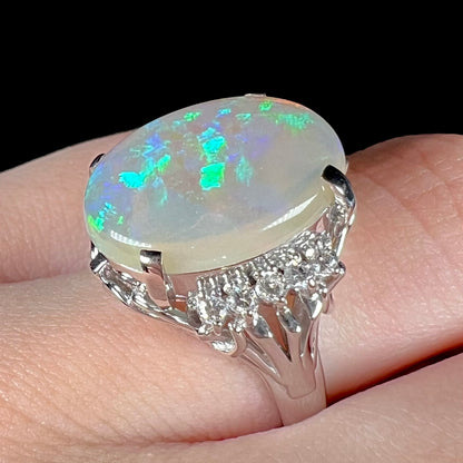 A platinum filigree ring set with a large, green-blue Mintabie crystal opal and diamonds.