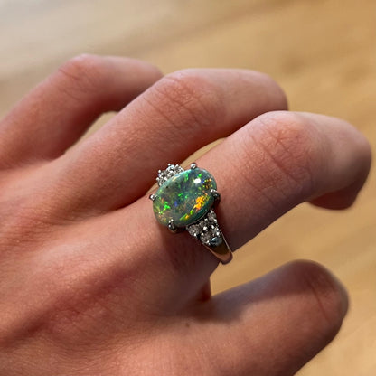 A multicolor Lightning Ridge opal and diamond-accented ring in platinum.