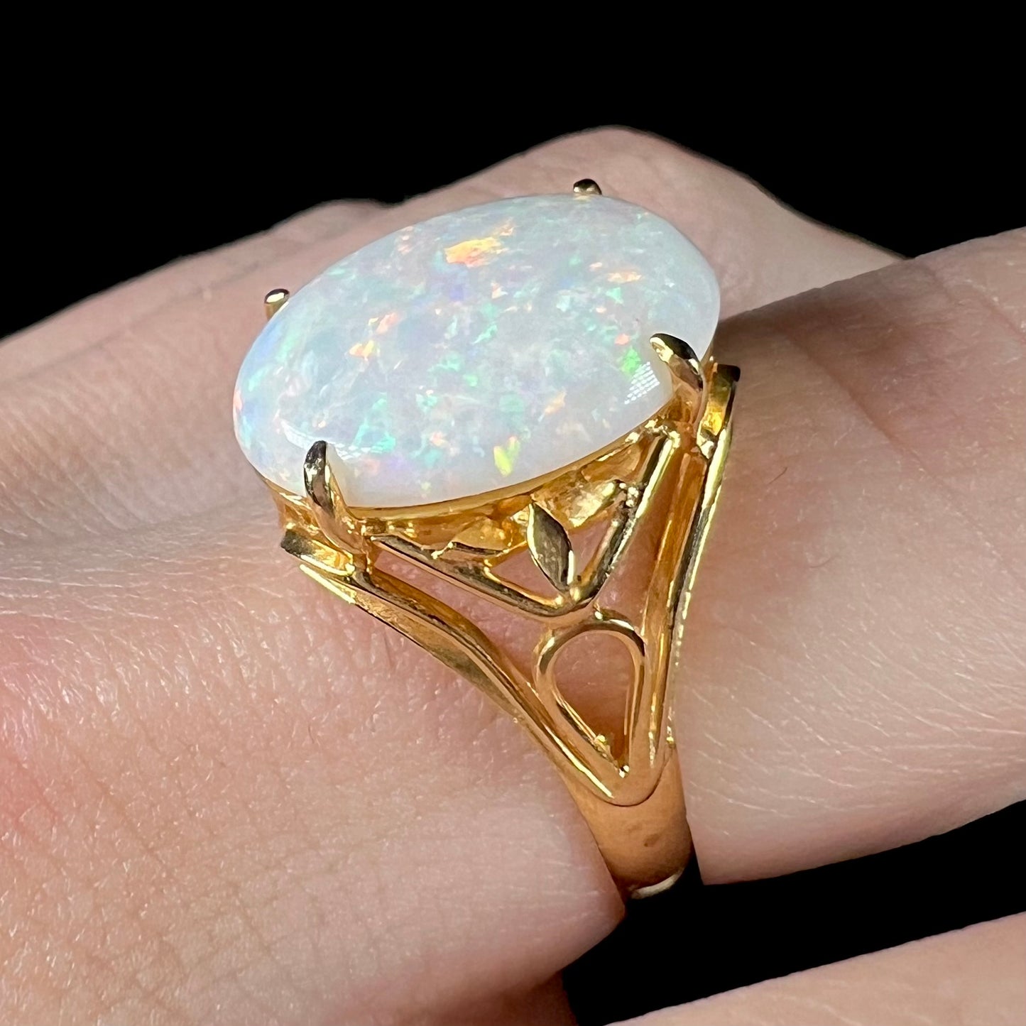 A yellow gold solitaire cocktail ring mounted with a natural white opal from Coober Pedy, Australia.