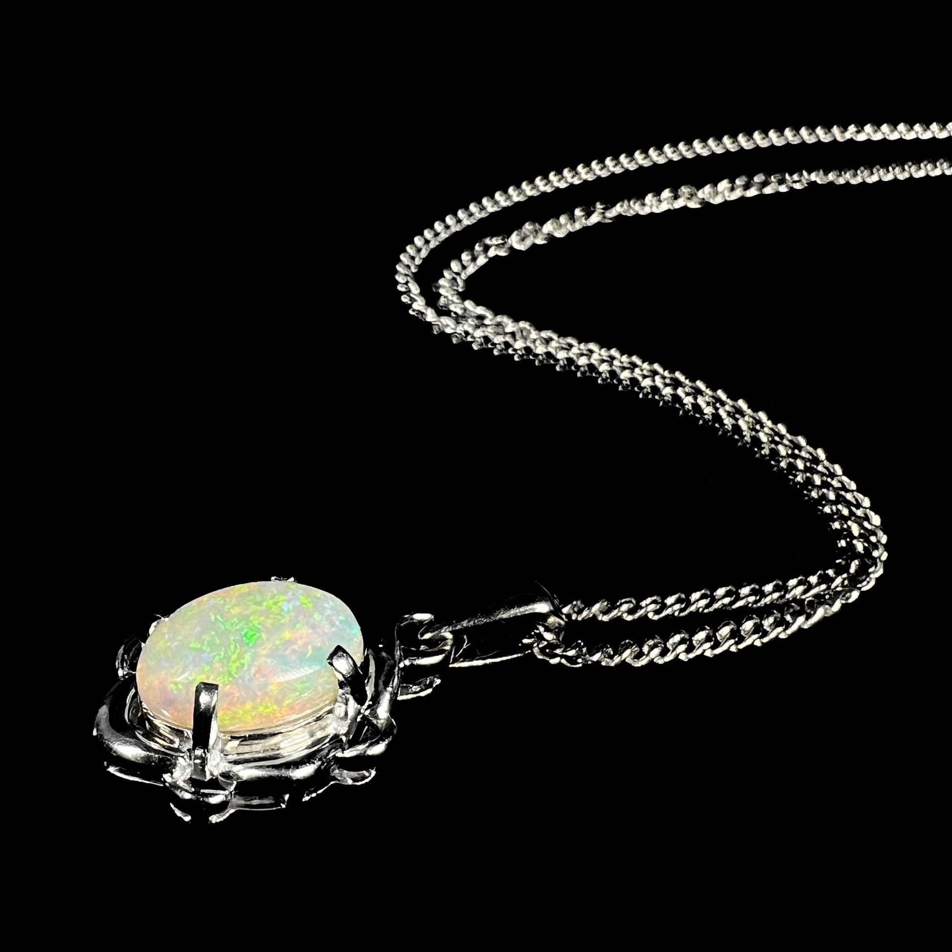 A platinum opal necklace on a platinum chain.  The opal weighs 1.49ct and has predominantly green color play.