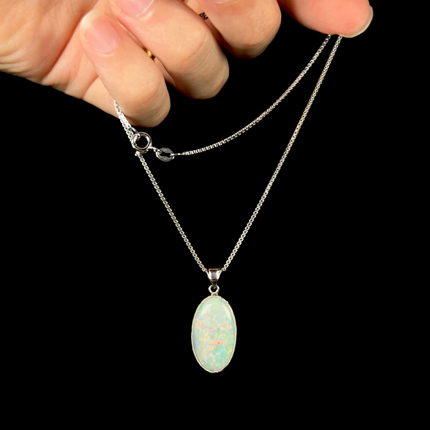 A platinum necklace mounted with an oval cut Australian white opal.