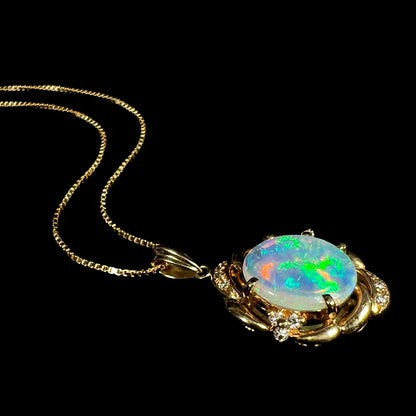 An 18 karat yellow gold diamond-accented necklace mounted with a green and blue Lightning Ridge crystal opal.