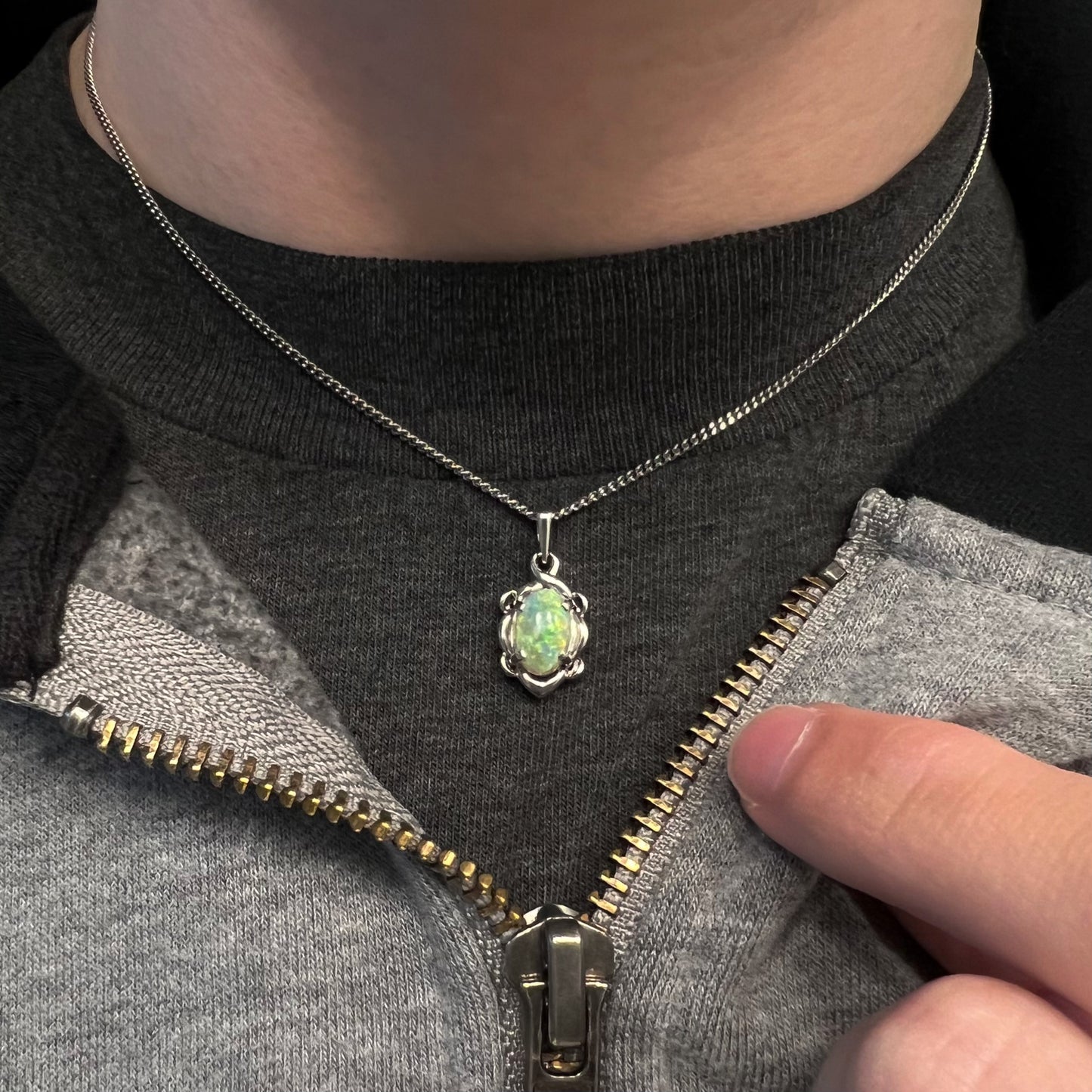 A platinum opal necklace on a platinum chain.  The opal weighs 1.49ct and has predominantly green color play.