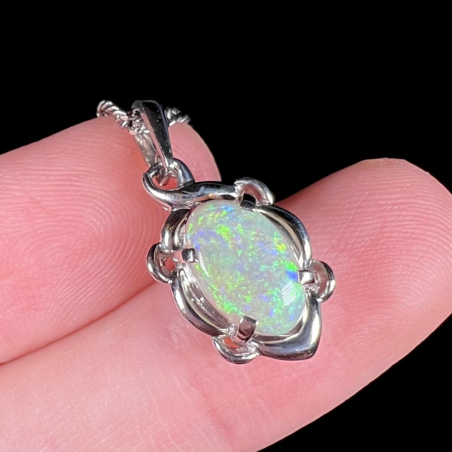 A platinum opal necklace on a platinum chain.  The opal weighs 1.49ct and has predominantly green color play.