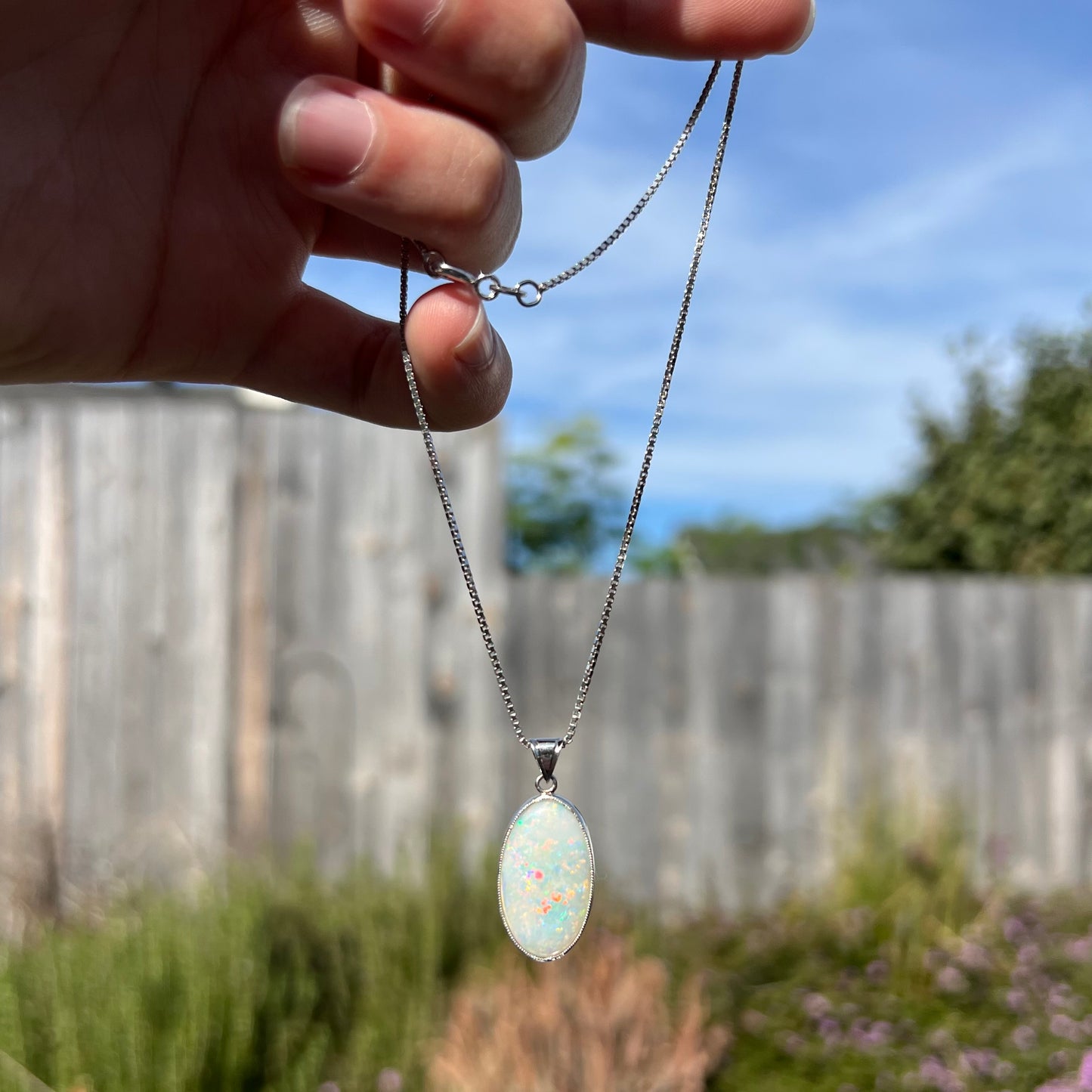 A platinum pendant mounted with an oval cut Australian white opal.