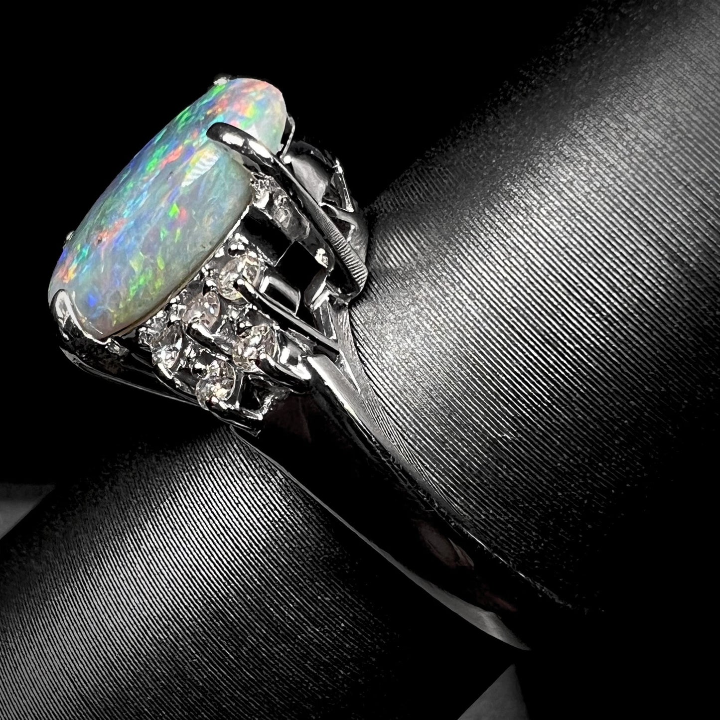 A multicolor Lightning Ridge opal and diamond-accented ring in platinum.