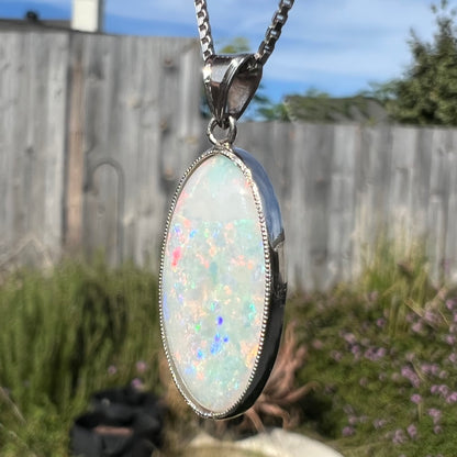 A platinum pendant mounted with an oval cut Australian white opal.