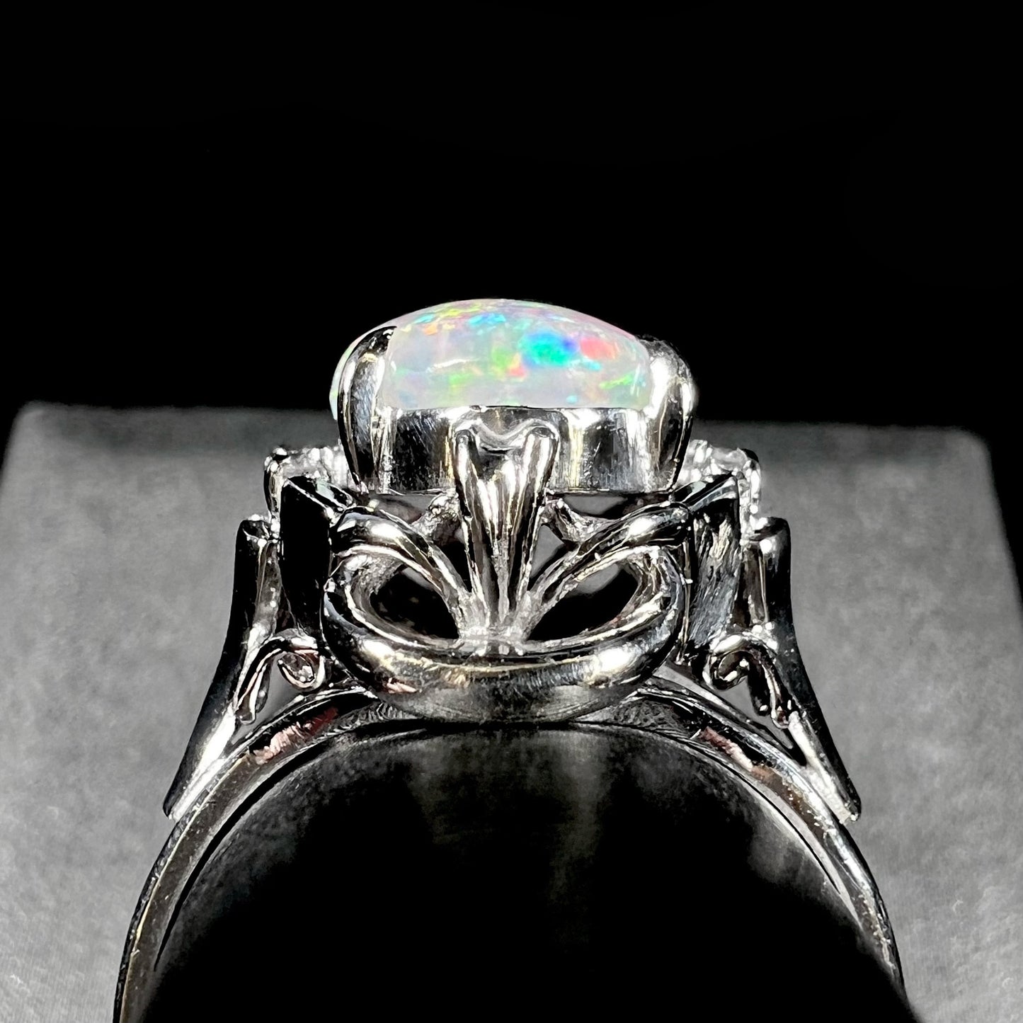 A platinum  and diamond ring prong-set with an Australian opal.  The opal has pink color play.