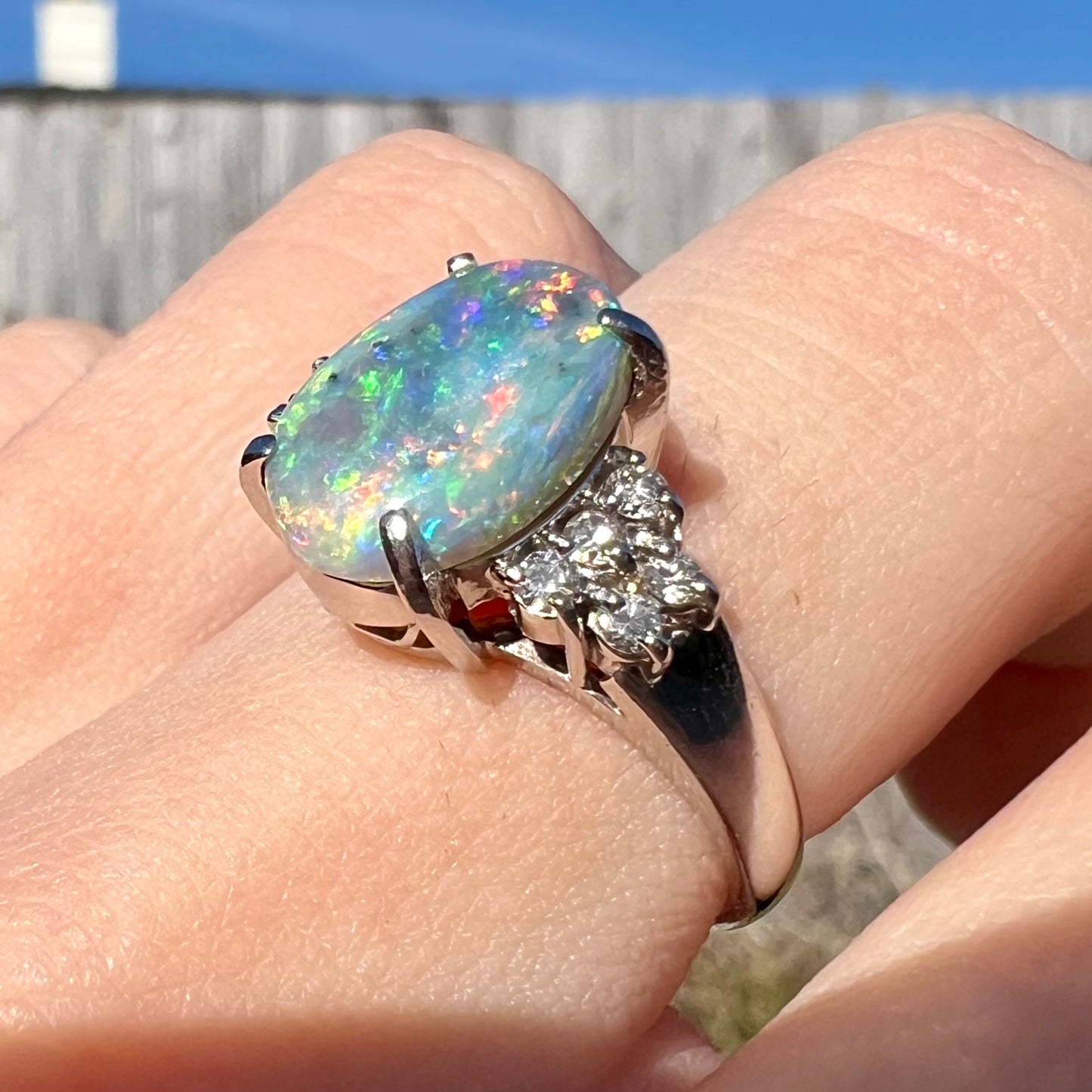 A multicolor Lightning Ridge opal and diamond-accented ring in platinum.