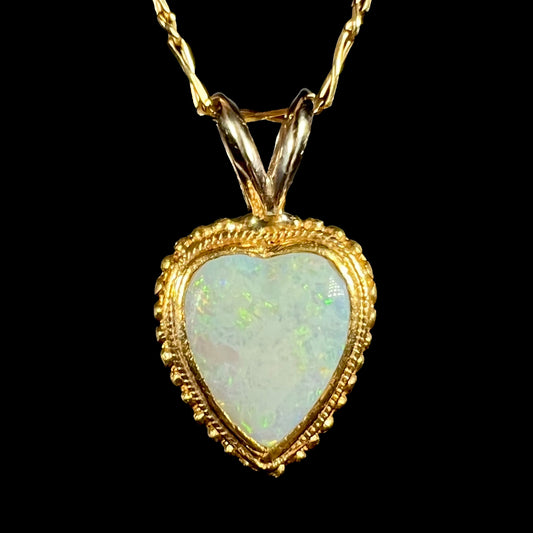 An 18 karat yellow gold heart necklace mounted with a heart shaped opal.