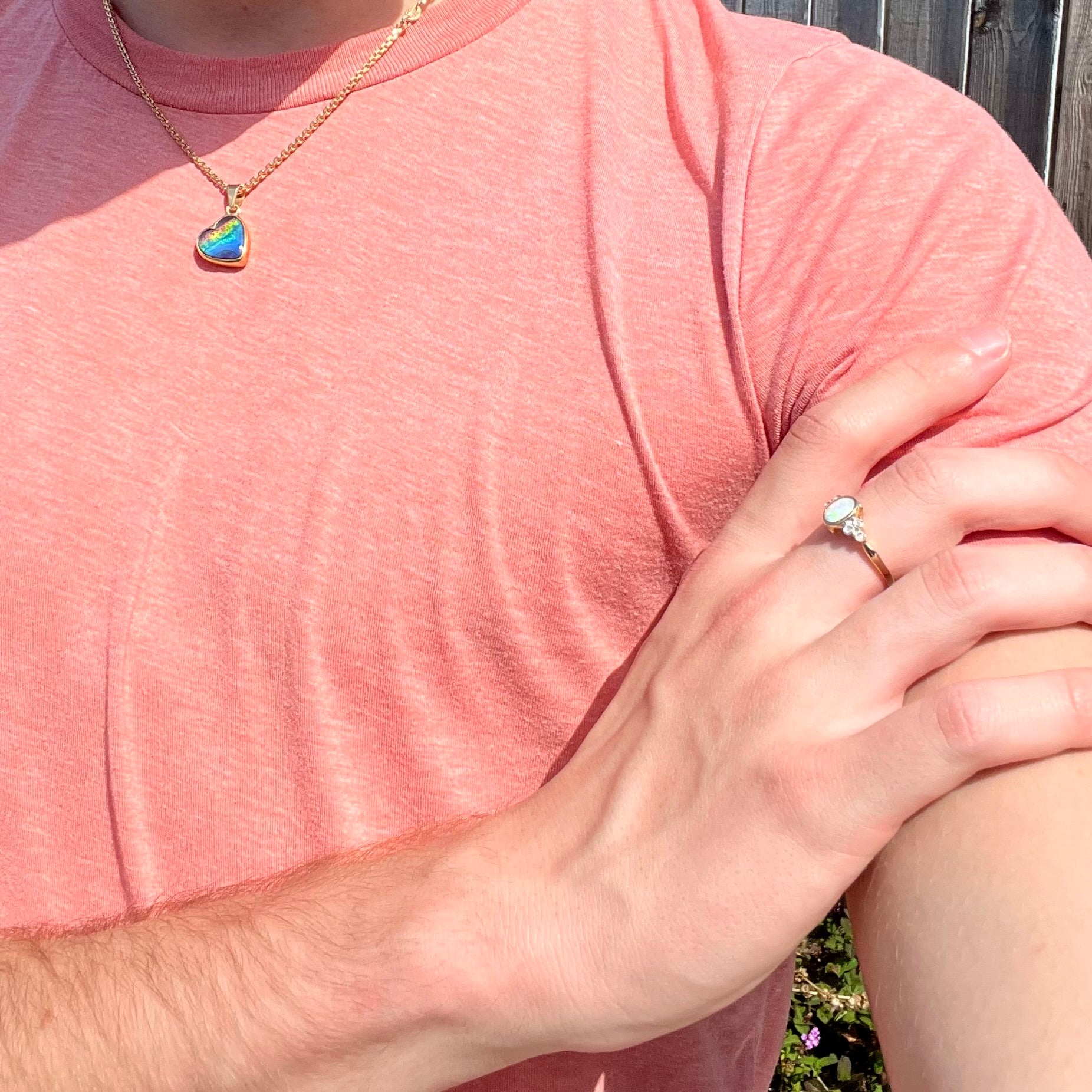 A ladies' yellow gold opal ring.  Three diamonds are set on each side of the opal.  Two rubies are set under the opal.