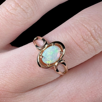 A 14 karat yellow gold open-shank design Australian crystal opal ring.