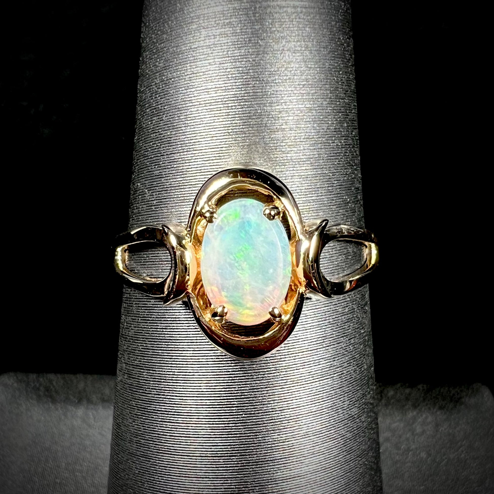 A 14 karat yellow gold open-shank design Australian crystal opal ring.