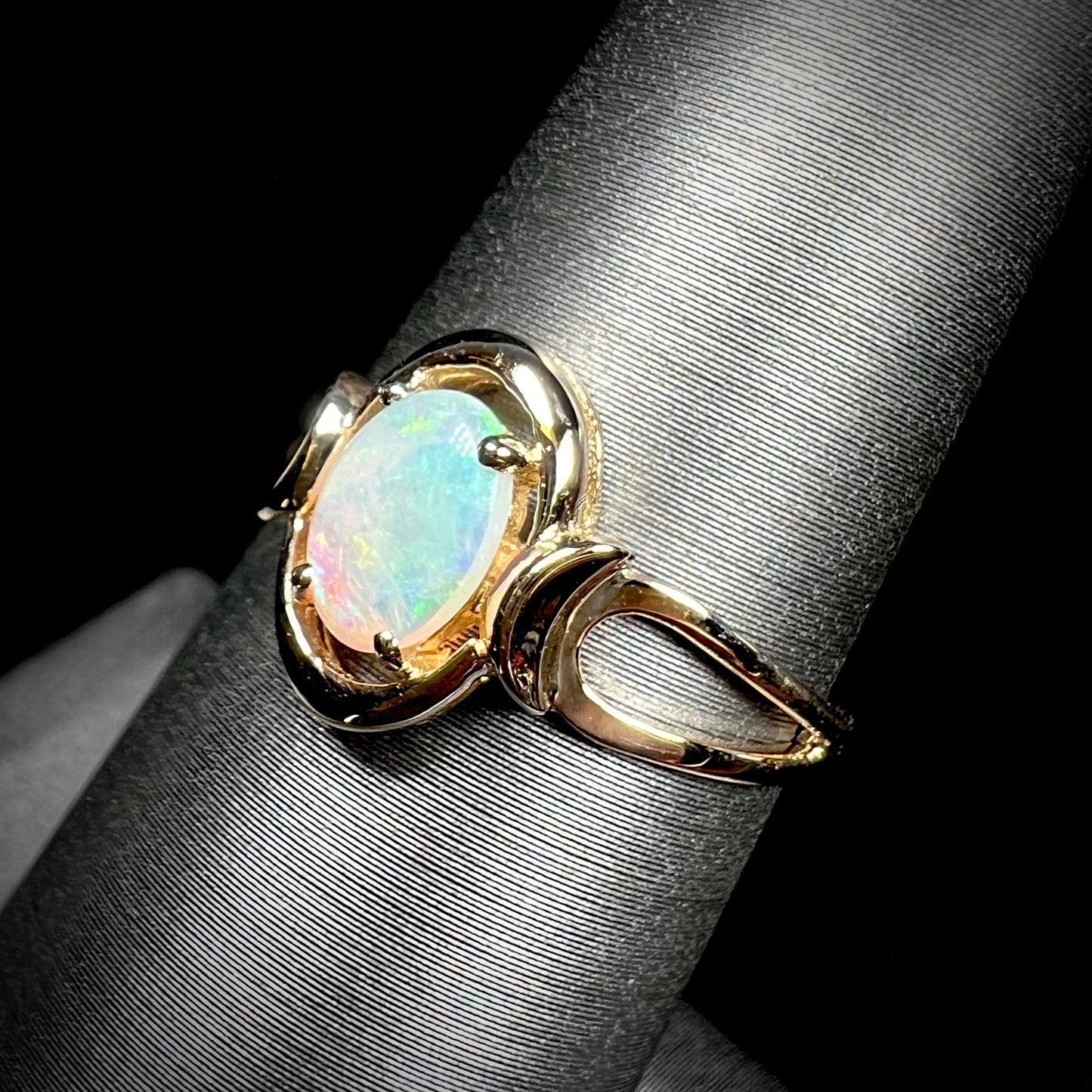 A 14 karat yellow gold open-shank design Australian crystal opal ring.