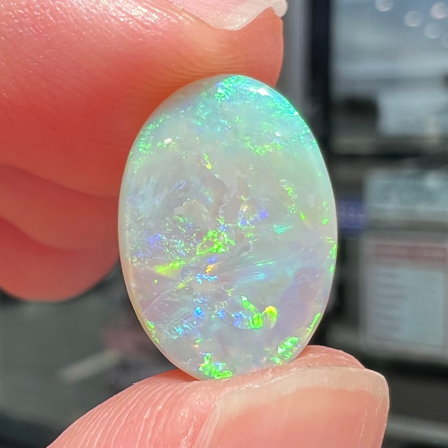 A double-sided opal stone from Coober Pedy, Australia.  The opal plays green, blue, and orange colors from the front and the back.