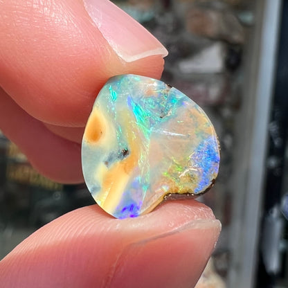 A loose, 5.90 carat heart shaped boulder opal stone from Quilpie, Australia.  The opal has blue flashes.