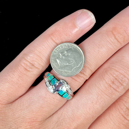 A ladies' white gold tanzanite ring with black opal doublet and diamond accents.