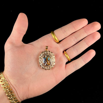 An antique 18 karat yellow gold pendant set with rough diamonds and an oval cut boulder opal from Koroit, Australia.