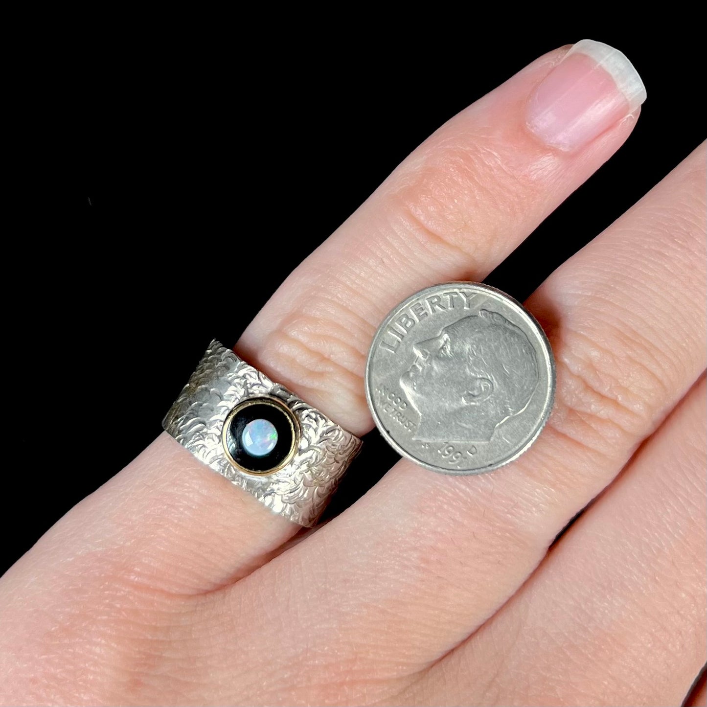 An opal and black onyx inlay ring in a sterling silver cigar-style pinkie ring.