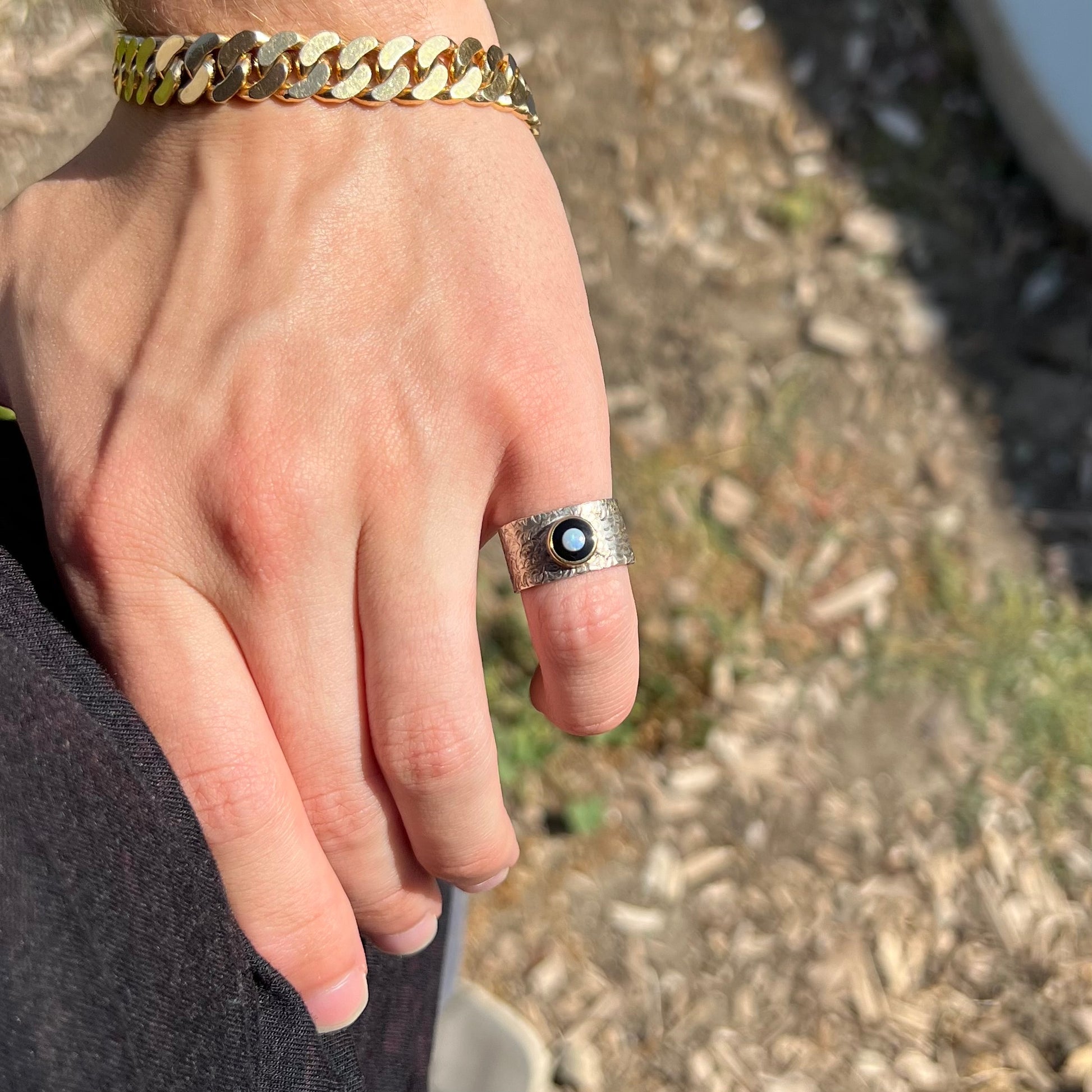 An opal and black onyx inlay ring in a sterling silver cigar-style pinkie ring.