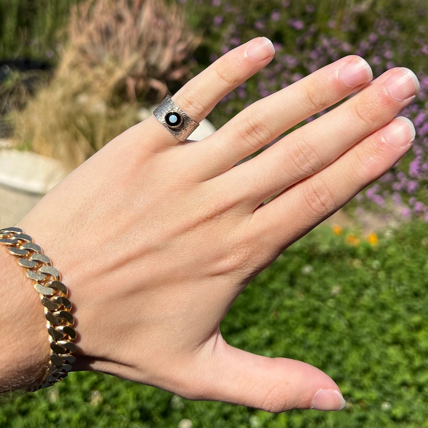 An opal and black onyx inlay ring in a sterling silver cigar-style pinkie ring.