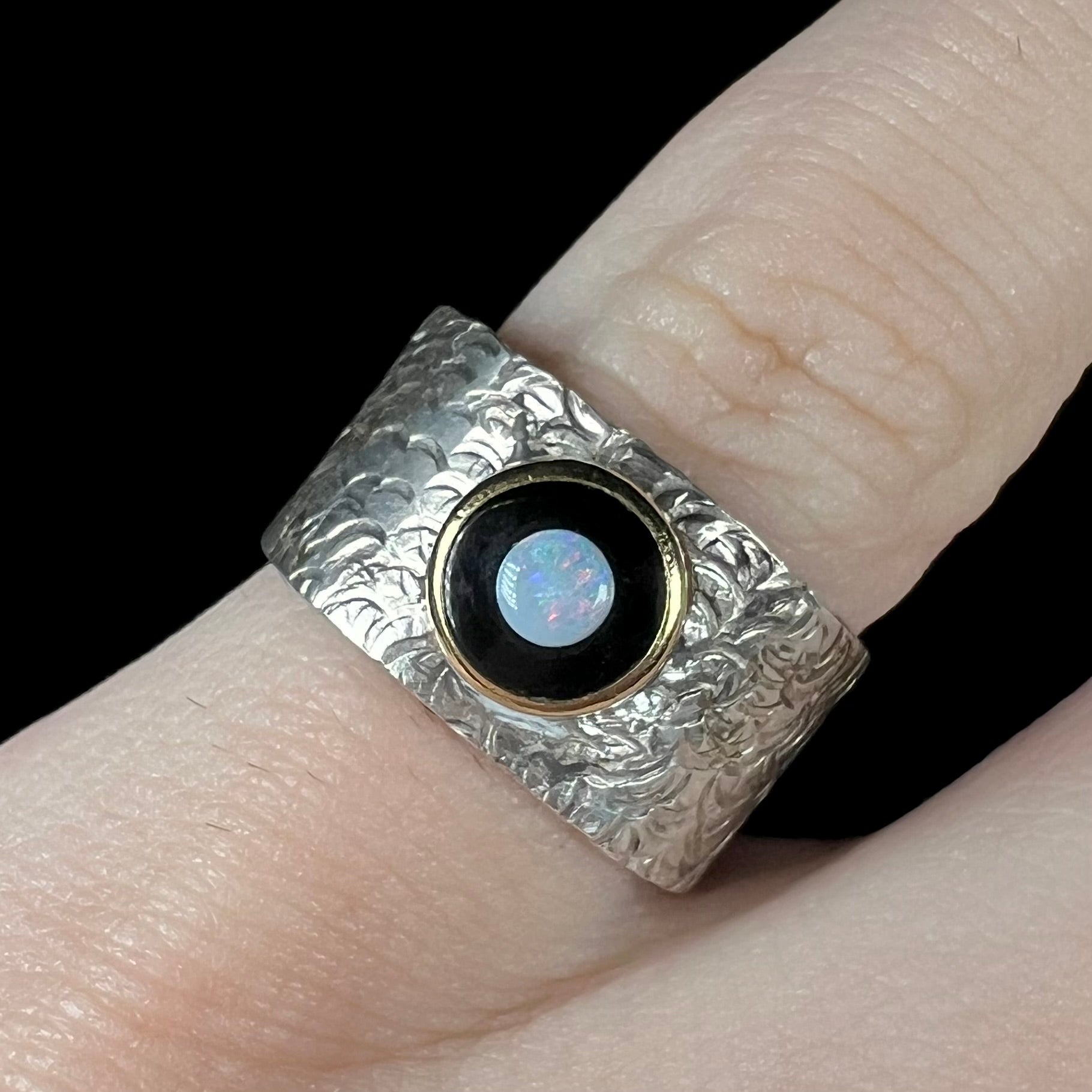 An opal and black onyx inlay ring in a sterling silver cigar-style pinkie ring.